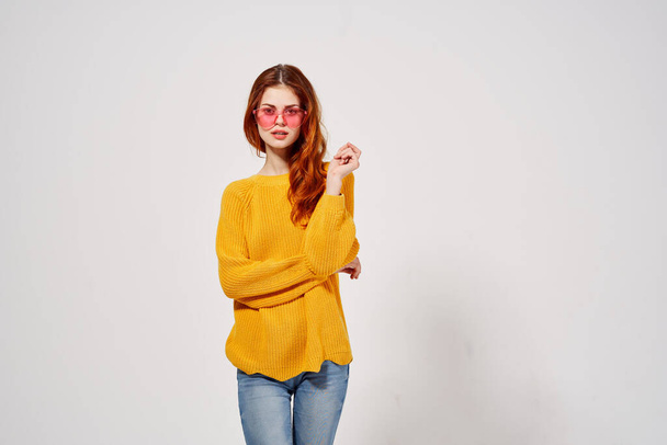pretty woman in a yellow sweater  posing in Studio - Photo, Image