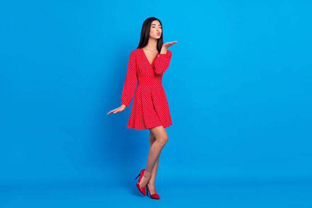 Full length body size view of attractive feminine dreamy lady sending air kiss isolated over vivid blue color background - 写真・画像
