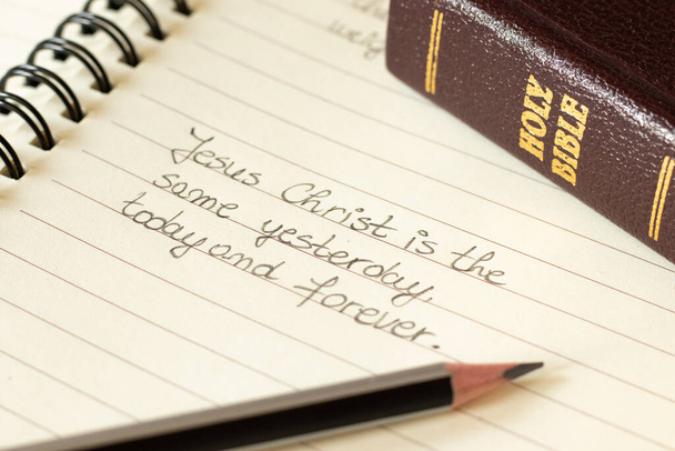 Jesus Christ is the same yesterday, today, and forever. A close-up of a handwritten quote with a closed Holy Bible. Unchanging love of the LORD. Everlasting, Merciful, Faithful God. Biblical concept. - Photo, Image