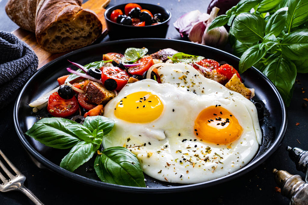 Sunny side up eggs with panzanella salad on wooden table - Zdjęcie, obraz
