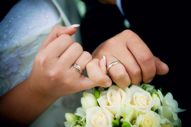 Hands with rings and wedding bouquet - Photo, Image