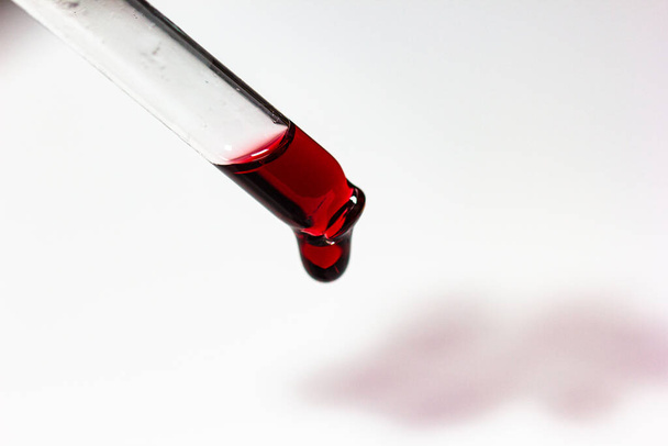 pipette with wine drops on white sheet with stains - Foto, imagen