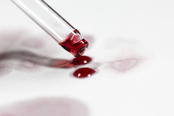 pipette with wine drops on white sheet with stains - Foto, Imagem