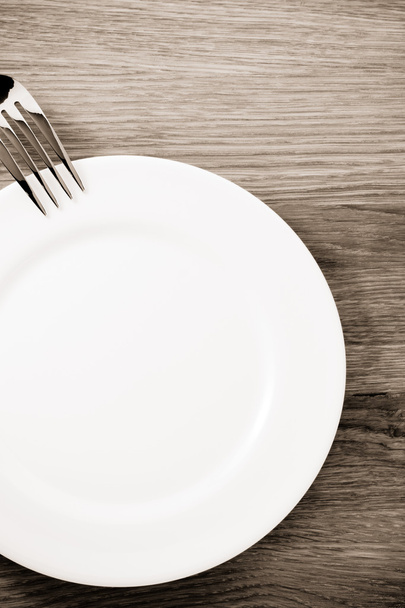  fork and plate at cutting board  - Фото, зображення