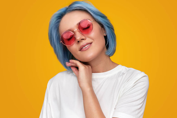 Young woman in trendy sunglasses touching face - Photo, image