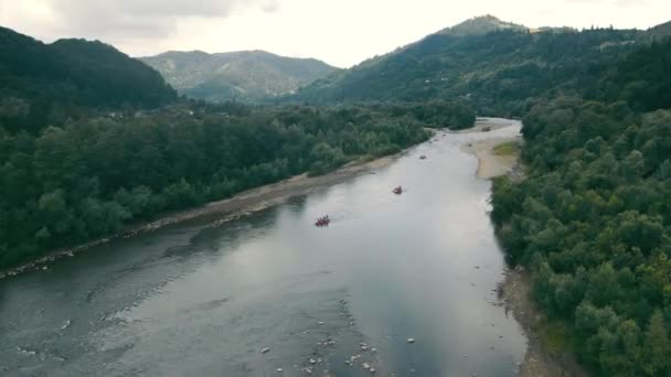 Aerial View from the top of the mountain landscape and the mountain river on which boats sail. Rafting on a mountain sloping river. - Footage, Video