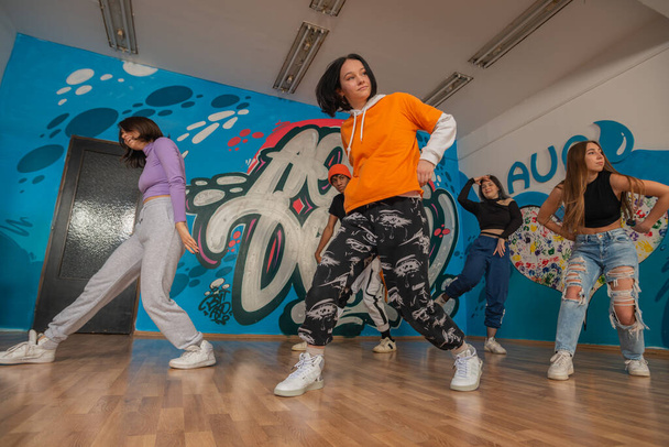 Young dancers in colorful wear having fun dancing hip-hop, enjoy being active. lifestyle, youth generation - Photo, Image