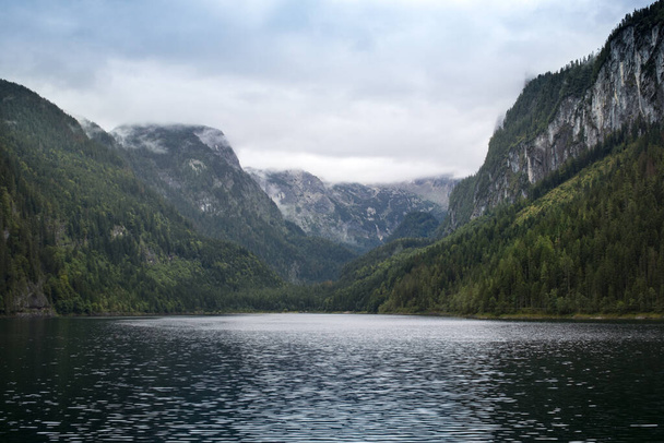 Lake in the mountains with cloudy peaks, and green forest, Alp, Upper Austria, Salzkammergut - Fotó, kép