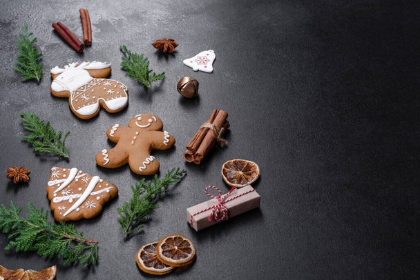 Christmas festive ginger gingerbread made at home on a dark table. Preparations for the New Year and Christmas - 写真・画像
