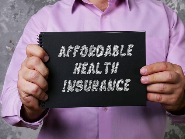 Business concept about AFFORDABLE HEALTH INSURANCE with sign on the piece of paper. - Фото, зображення