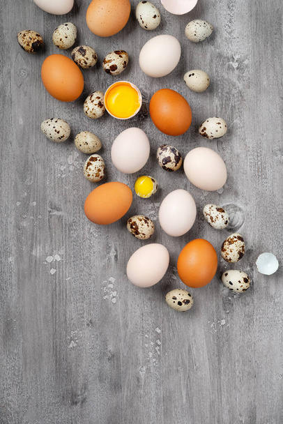 Top view of chicken and quail eggs on table - Photo, Image