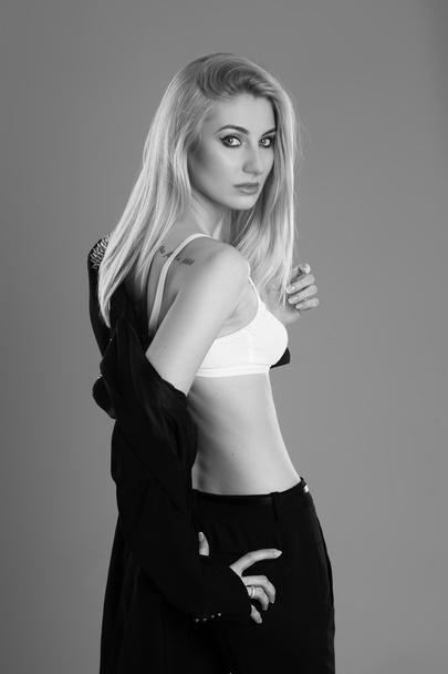 Beautiful blond woman with long hairstyle poses at studio - Fotografie, Obrázek