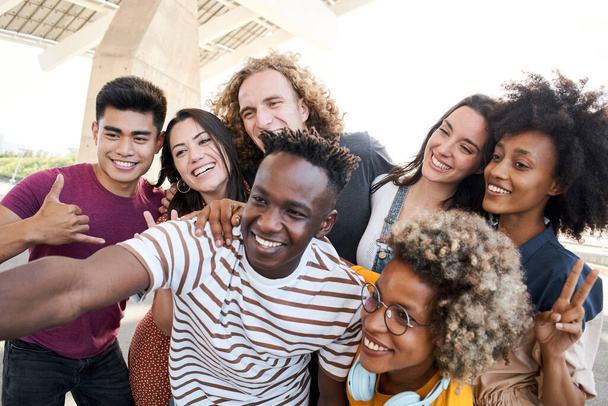 Portrait of friends take a picture with a mobile phone. Multiethnic concept, selfie, friendship. - Photo, Image