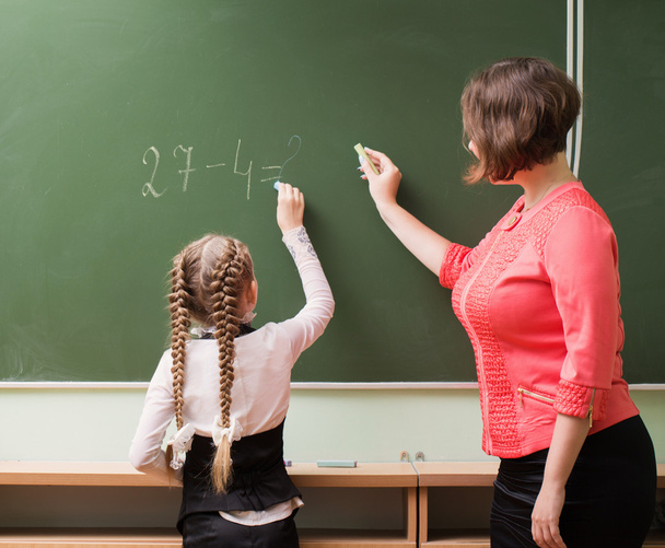 Schoolgirls and teacher in the classroom - Foto, Bild