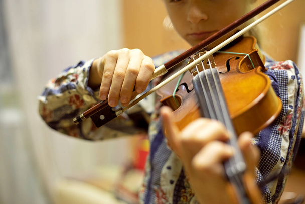 happy attentive young violinist playing violin music, horizontal - Fotó, kép