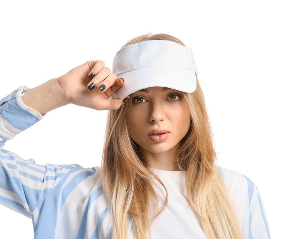 Portrait of young woman in visor hat on white background - Photo, Image