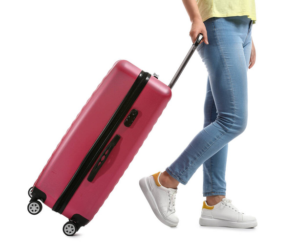 Young woman with suitcase on white background - Φωτογραφία, εικόνα