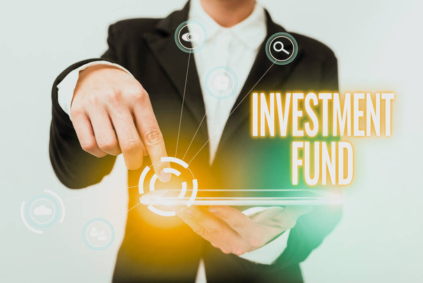 Text sign showing Investment Fund. Business idea A supply of capital belonging to numerous investors Lady In Suit Pointing On Tablet Showing Futuristic Graphic Interface. - Photo, Image
