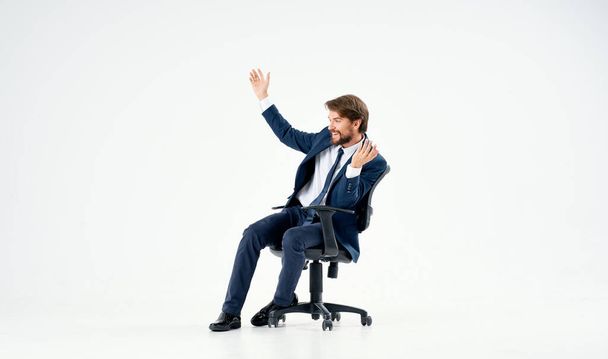 emotional business man in office chair work light background - Foto, imagen