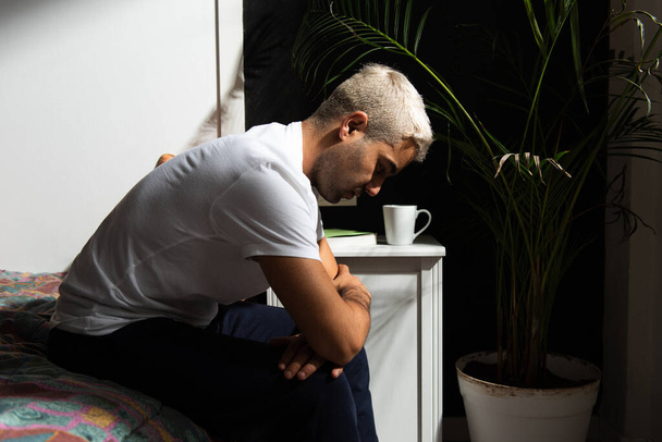 Depresivní hispánec sedící na posteli a přemýšlející o svých problémech. Stres, úzkost, deprese a koncepce duševního zdraví. - Fotografie, Obrázek