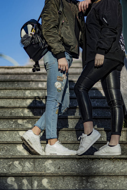Milan, Italy - February 25, 2017: Young man and woman wearing Nike Air Max 90 and Adidas Superstar in the street - Foto, Imagem