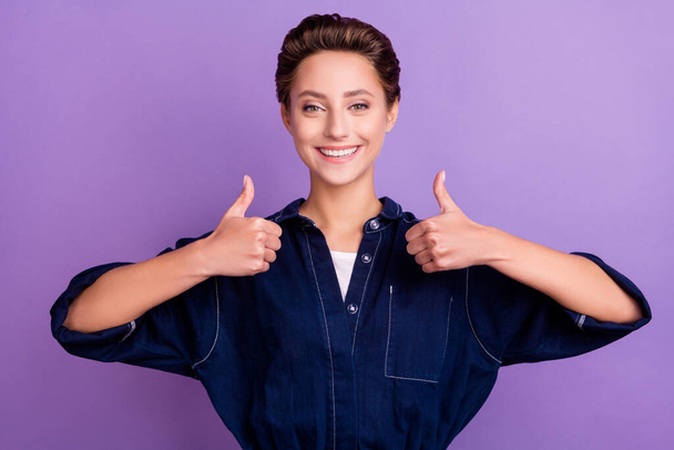 Photo of funny young short hairdo lady thumb up wear jeans overall isolated on violet color background - Foto, immagini