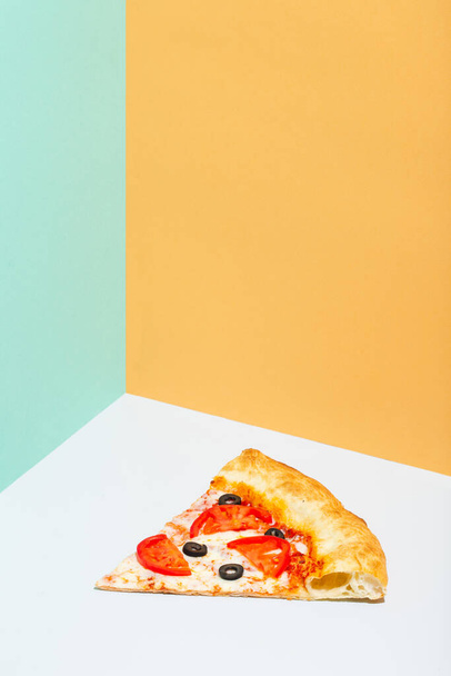 slice of pizza margarita on paper grey and orange background - Fotoğraf, Görsel
