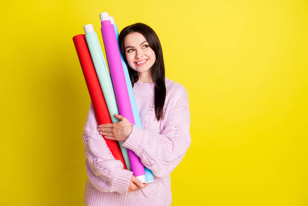 Photo of romantic millennial lady cuddle rolls look empty space want pack present wear sweater isolated on yellow background - Foto, afbeelding
