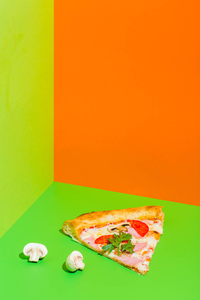 pizza with ham and mushrooms on paper green and orange background - Fotoğraf, Görsel