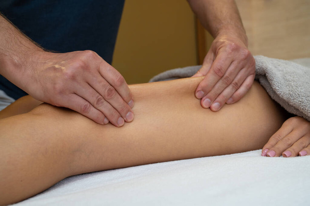 Woman getting legs massage in spa salon - Foto, afbeelding