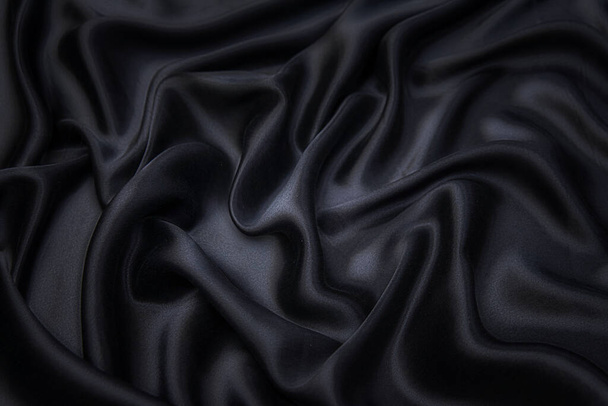 Textura de tela, fondo para el diseño. Textura de seda negra o tela de algodón o lana. Hermoso patrón de tejido ondulado. - Foto, Imagen
