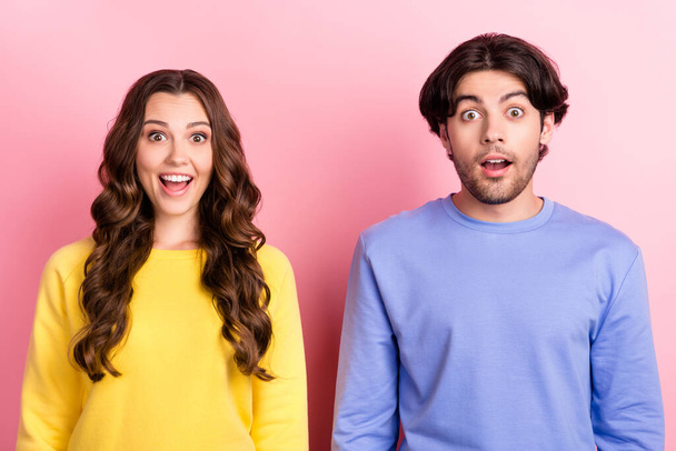 Photo of young excited couple happy positive smile amazed surprised wow information sale isolated over pink color background - Φωτογραφία, εικόνα