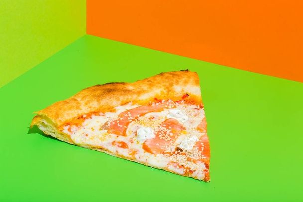 Pizza with Mozzarella cheese, salmon fish. Italian pizza on green paper background - Valokuva, kuva