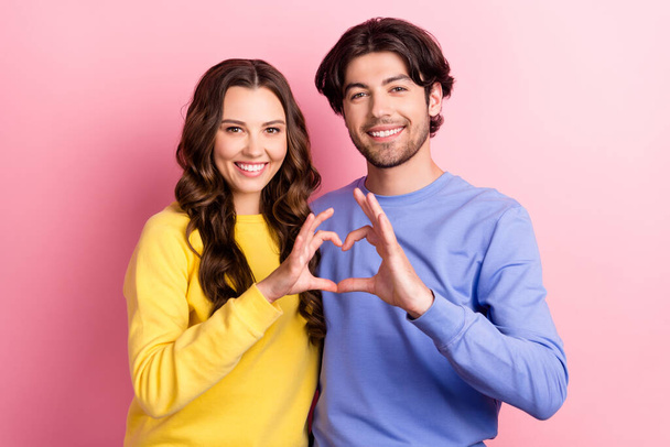 Photo of young cheerful couple happy positive smile show fingers heart symbol love isolated over pink color background - Fotografie, Obrázek