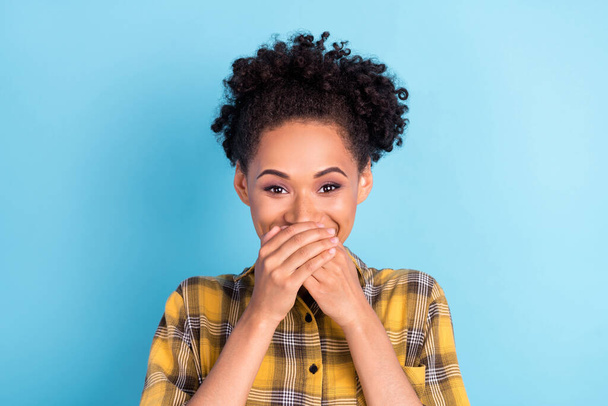 Photo portrait curly woman wearing checkered shirt covered mouth with hands keeping secret isolated pastel blue color background - Φωτογραφία, εικόνα