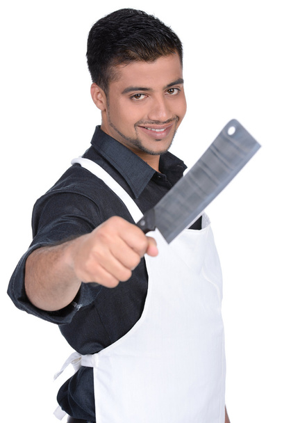 Man wearing apron holding knife. handsome butcher smiling and holding knife - Foto, Bild