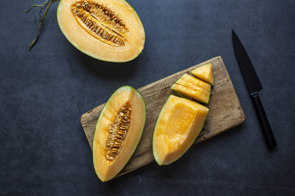 Fresh Juicy honeydew melon sliced on dark gray background .healthy food.hami melon. - Foto, immagini
