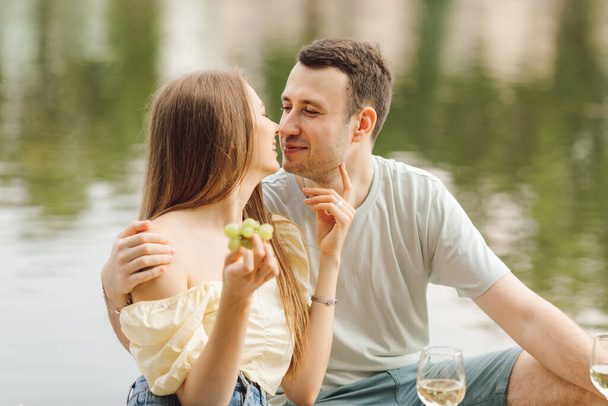 Romantic picnic in nature makes it possible to give tenderness and care to couple in love. Happiness and serenity. Rest and enjoyment.Beautiful moments of life. Super day. Romantic relationships. - Photo, Image