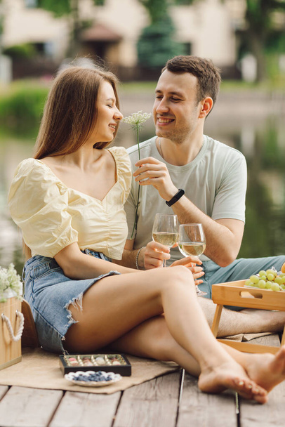 Romantic relations on picnic on summer day on heated wooden terrace. Sweet life. Happiness and serenity. Rest and enjoyment. Wonderful moments of life. Super day. Romantic relationships. - Valokuva, kuva