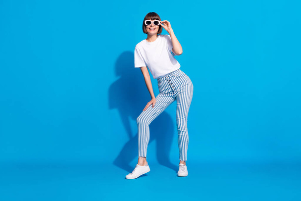Full length body size photo careless girl in sunglass wearing stylish outfit isolated bright blue color background - Φωτογραφία, εικόνα
