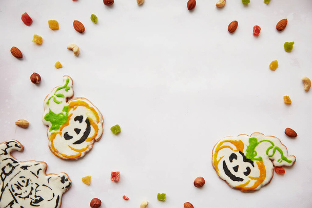 Halloween creative treats: homemade pumpkin cookies with dried fruits, candied fruits, cashews, hazelnuts. Trick or treat concept. Autumn cozy home concept with healthy snacks. Copy space. - Photo, Image