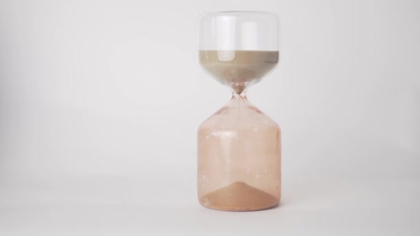 Close-up, beautiful glass hourglass on a white background - Footage, Video
