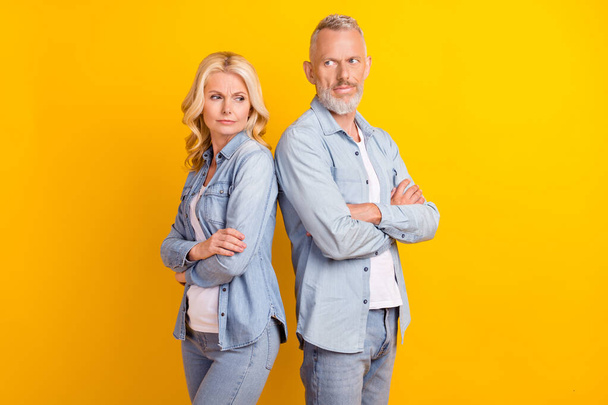 Photo of old unhappy sad upset retired couple people crossed hands conflict isolated on yellow color background - Valokuva, kuva