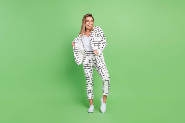 Full size photo of joyful dreamy happy woman god mood wear suit smile isolated on green color background - 写真・画像