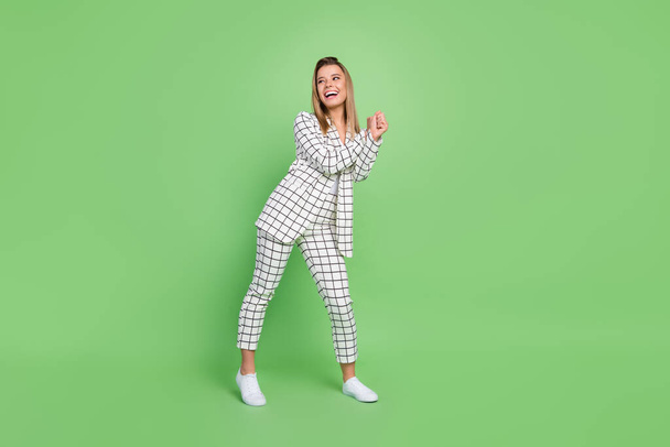 Full length body size view of attractive cheerful elegant chic lady dancing wearing formal suit having fun isolated over green color background - Φωτογραφία, εικόνα