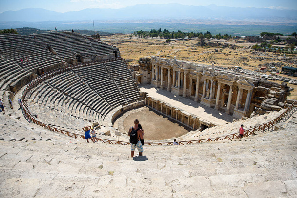 Turkey, Hierapolis - September 22, 2021. Tourists look at the ancient theater - Фото, изображение