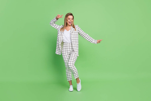 Full length body size view of attractive cheery businesswoman showing v-sign having fun isolated over bright green color background - Foto, Bild