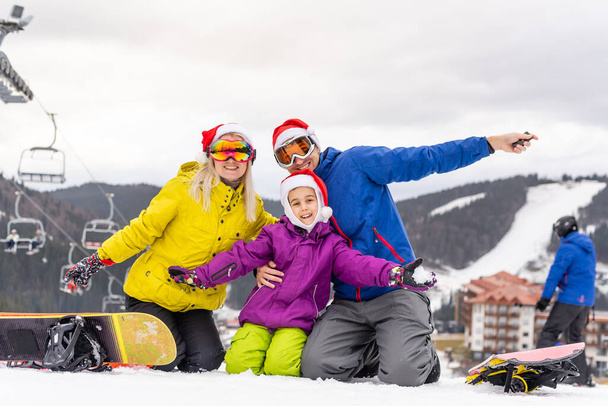 rodina v Santa klobouky a snowboardy - Fotografie, Obrázek