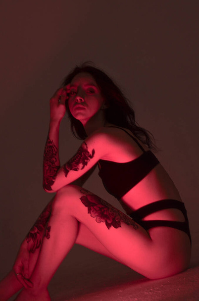 erotic girl in lingerie sits on the floor and in pink - Valokuva, kuva