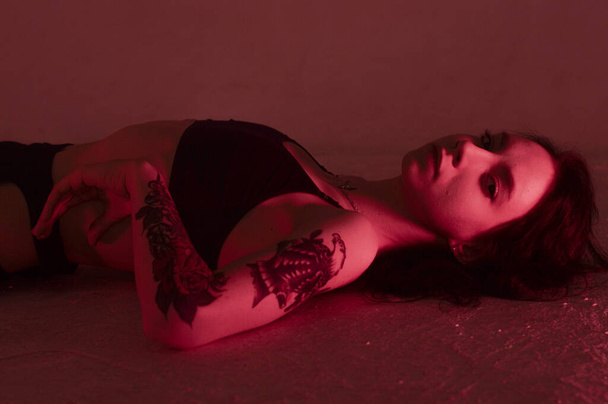 erotic girl in pink lies on the floor in underwear. - Fotó, kép